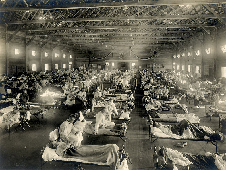 black and white photo of overflowing hospital ward filled with cots and patients